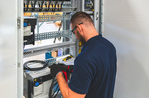 Electrician Working on Panel